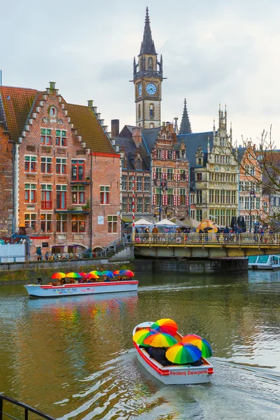 Tourist boats in rainy day on river Leie, Ghent, Belgium