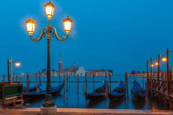 Gondolas at twilight in Venice lagoon, Italia