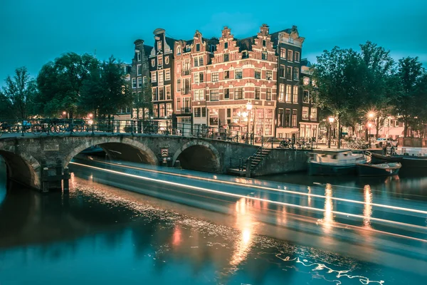 Night city view of Amsterdam canal and bridge