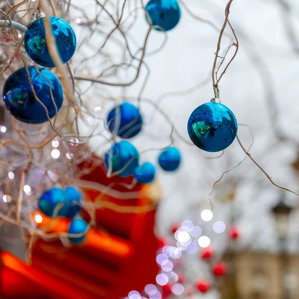 Blue shiny balls on Christmas street in Paris, France