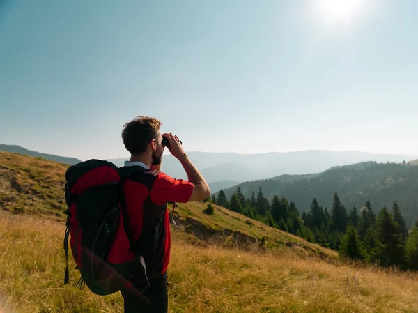 Man looking through binoculars