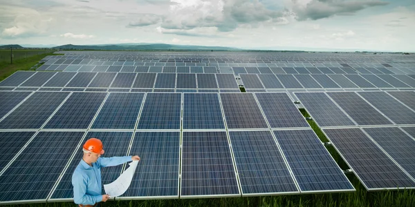 Engineer inspecting solar panel station