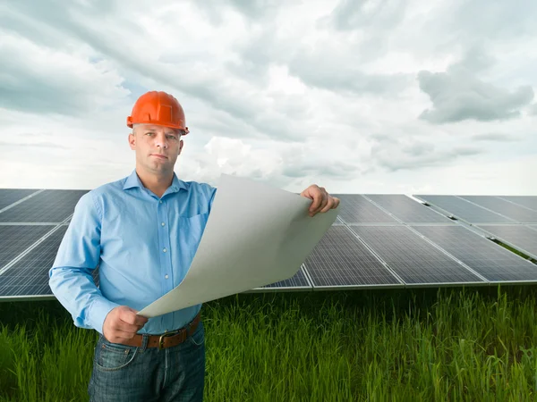 Engineer holding solar panel station plan