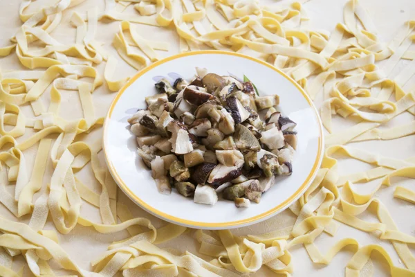 Homemade tagliatelle on a pastry board