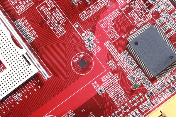 Close-up of red electronic circuit board with processor
