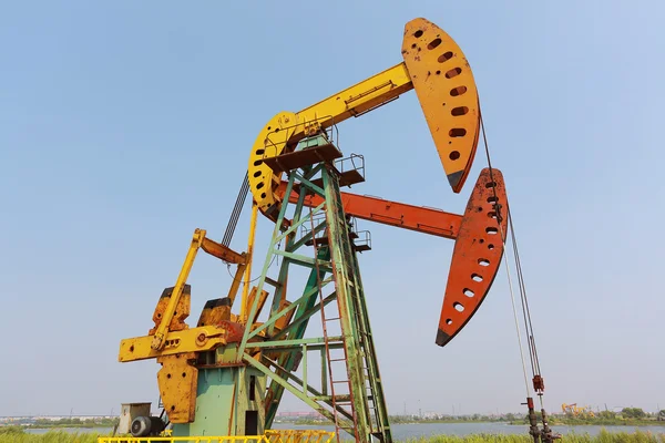 Golden yellow and orange Oil pump of crude oilwell rig