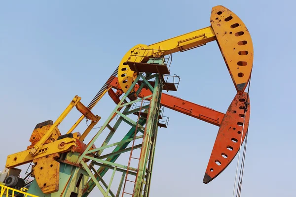 Golden yellow and red Oil pump of crude oilwell rig