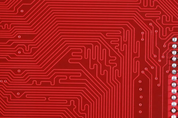 Close-up of electronic circuit red board background