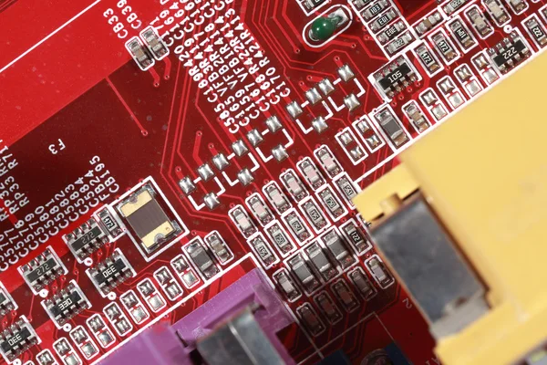 Close-up of electronic circuit red board with processor