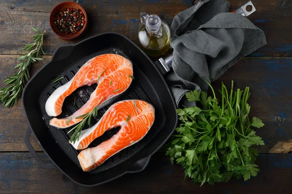 Salmon Steak on griddle pan and rosemary, parsley, spice