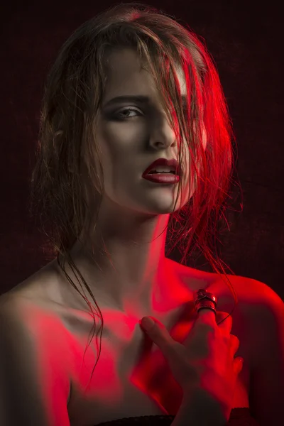 Stunning woman in red half-light