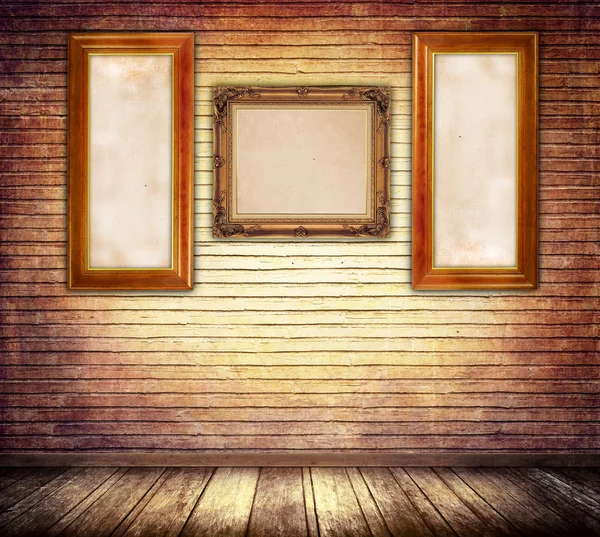 Decorative vintage wooden frames on bricks wall.