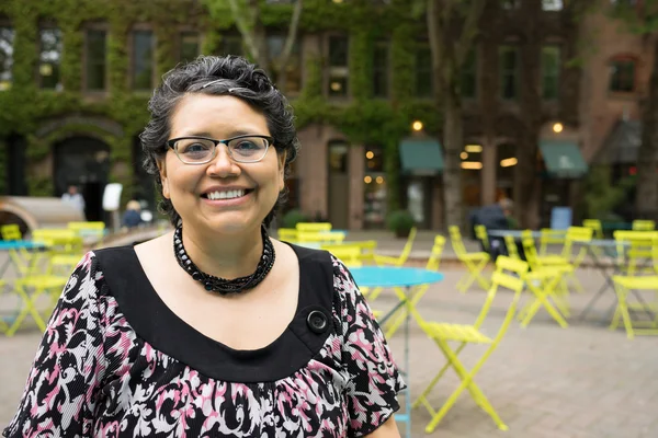 Happy Hispanic Woman In 40's Enjoys Outdoor Dining
