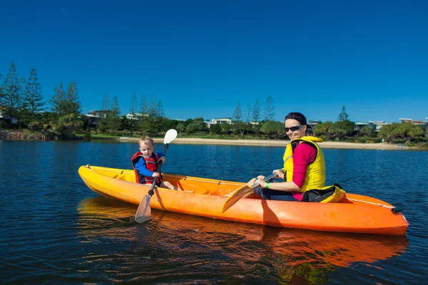 Mother and son kayaking in a small lake