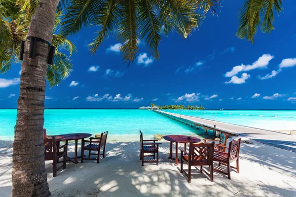 Tables and chairs on tropical island