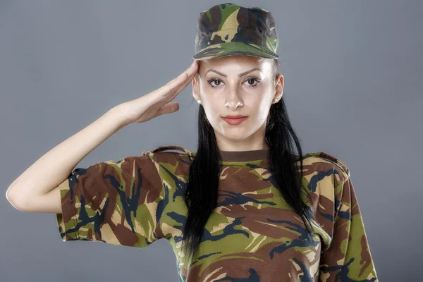Woman army soldier saluting isolated on gray background