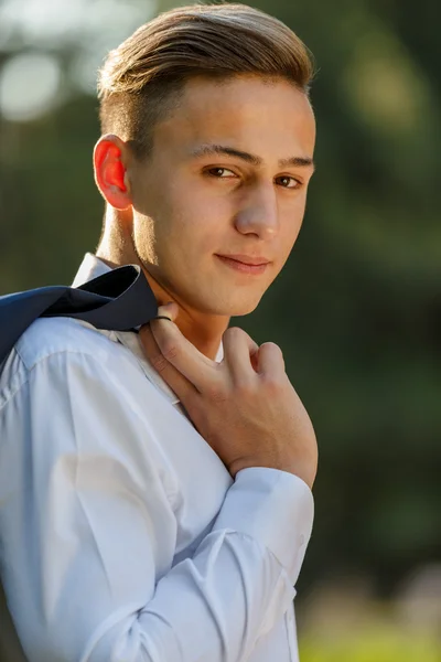 Young businessman relaxes in park