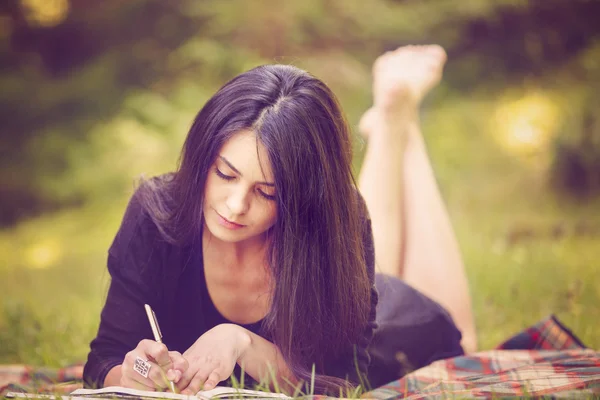 Beautiful woman writer is inspired by nature