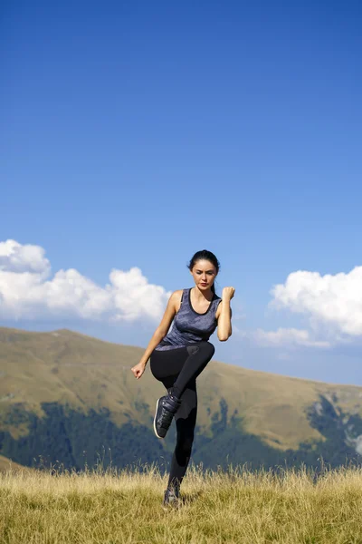 Exercising fitness woman doing exercises in nature. Girl doing m