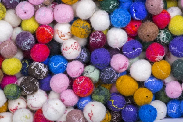 Background of multi-colored balls of wool felted