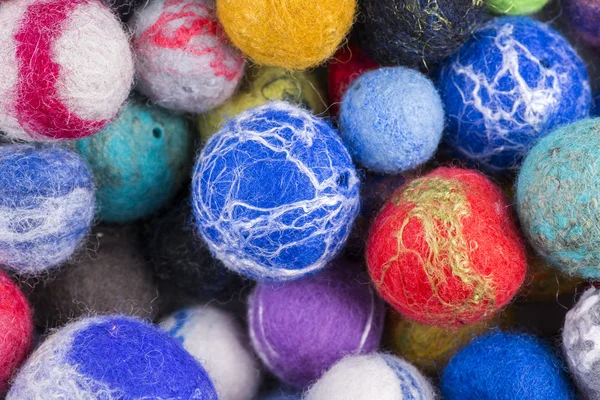 Background of multi-colored balls of wool felted