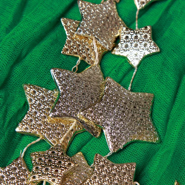 Golden stars over green background