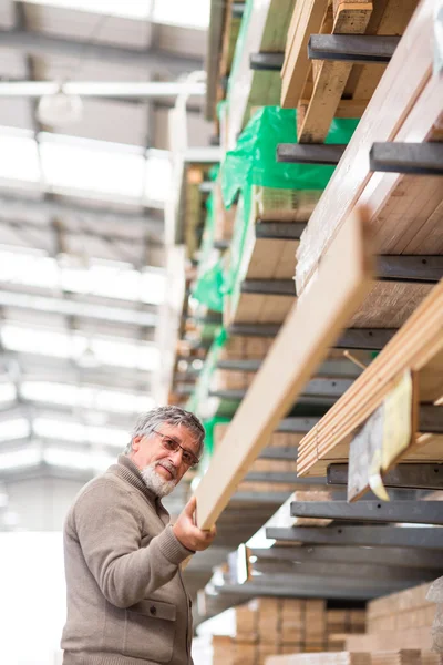 Man choosing and buying construction wood