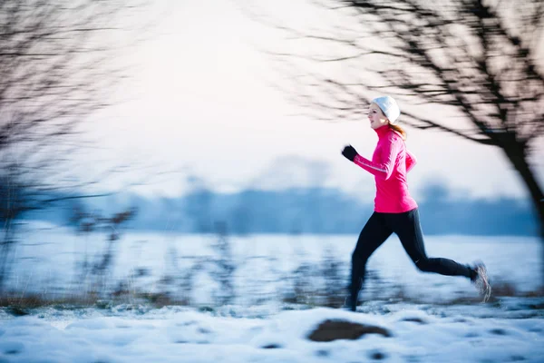 Young woman running outdoors on a cold winter day