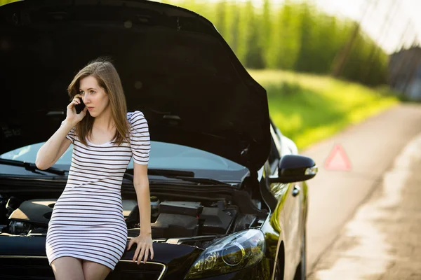 Woman calling the roadside service, assistance