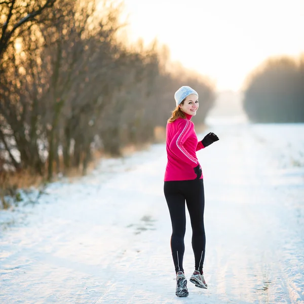 Woman running outdoors on a cold winter day