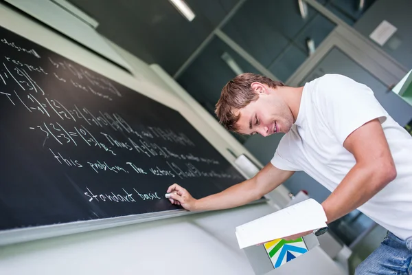 Handsome college student solving a math problem