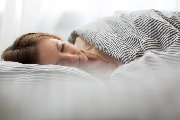 Beautiful young woman sleeping in bed