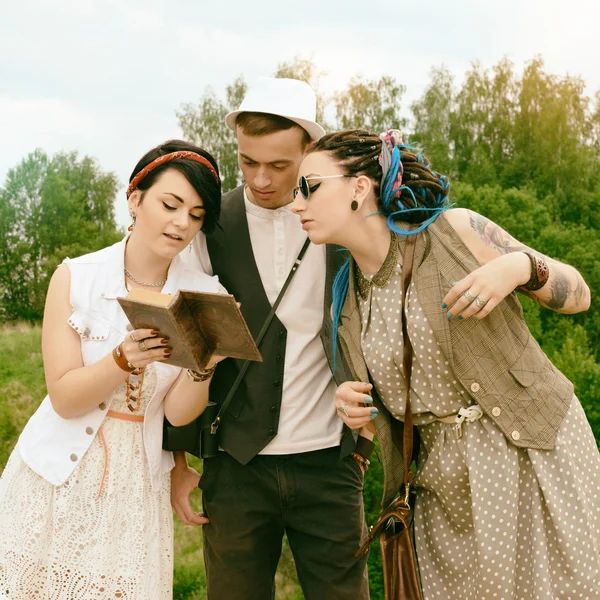 Guy and girls hipsters are engaged in self-development by book a