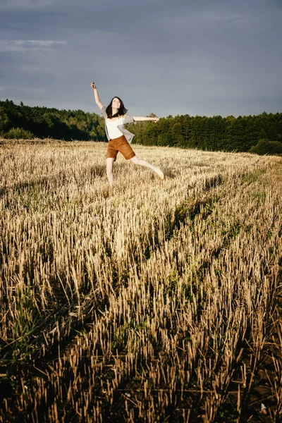 Young beautiful free happy woman jumps happy with smile