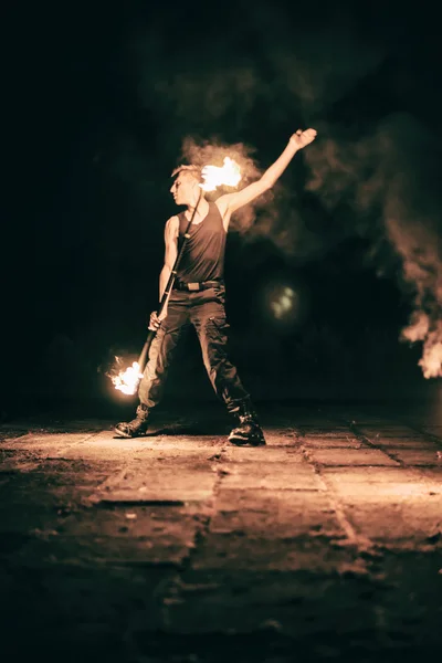 Active European guy carries out tricks for fire show night