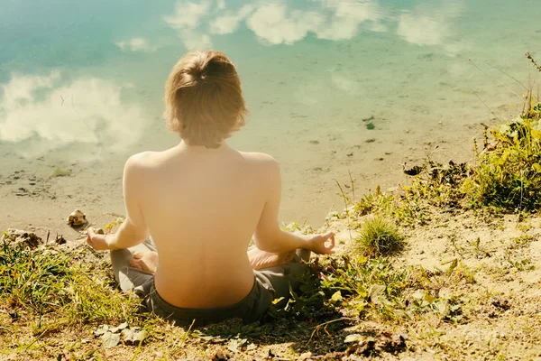 Man practices asanas on yoga in harmony with nature