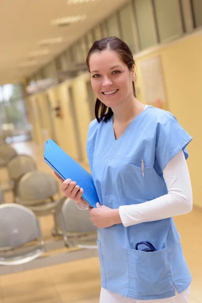 Nurse in hospital standing with patient file