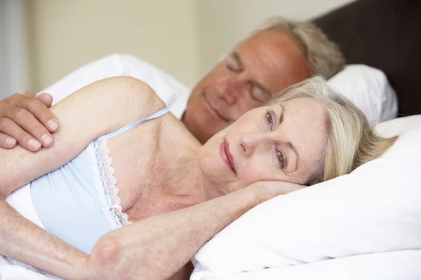 Senior Man In Bed With Worried Wife