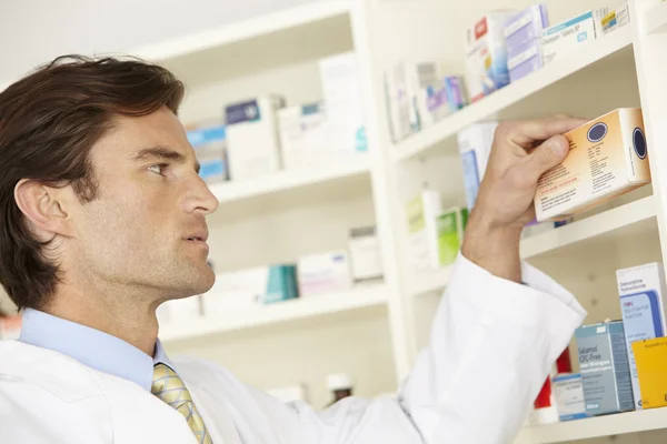 Male pharmacist working in pharmacy