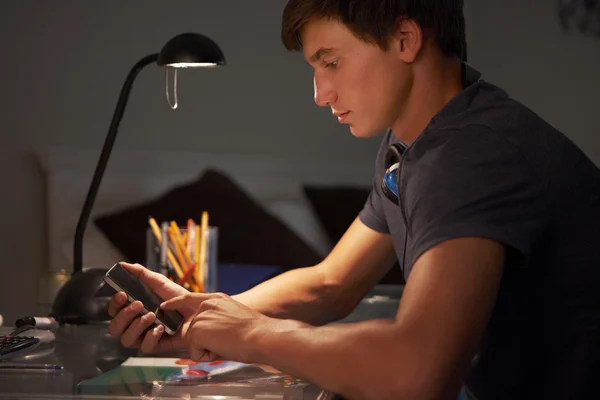 Teenage Boy Texting On Phone