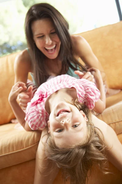 Mother And Daughter Having Fun On Sofa