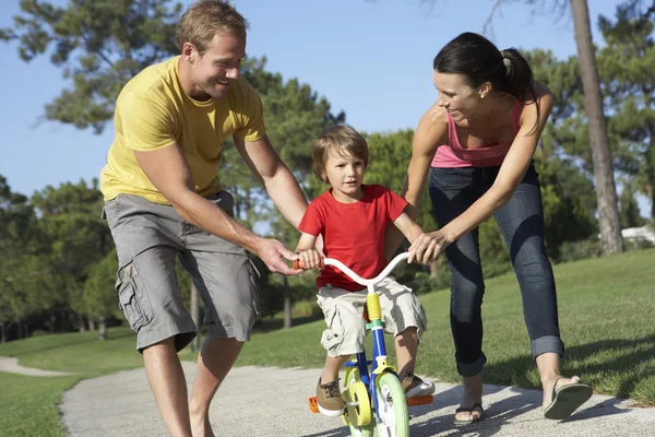 Parents Teaching Son To Ride Bike