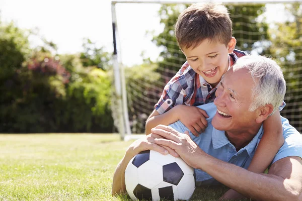 Grandfather And Grandson With Football