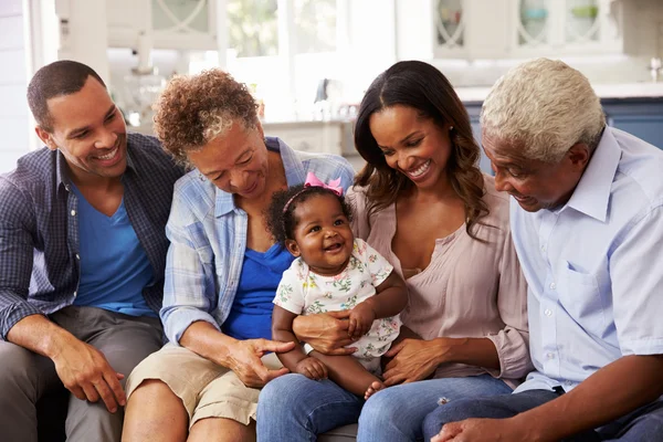 Grandparents, parents and a happy baby girl