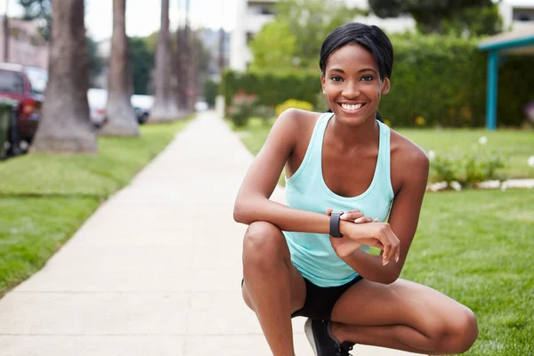 Young woman checking smart watch