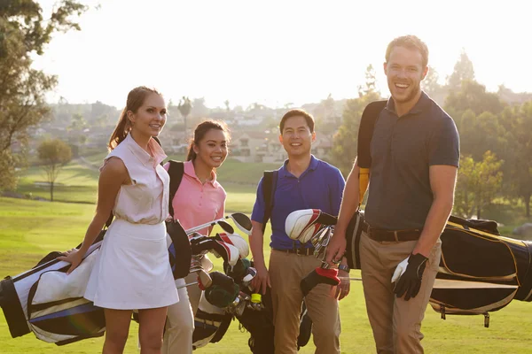 Group Of Golfers Carrying Golf Bags