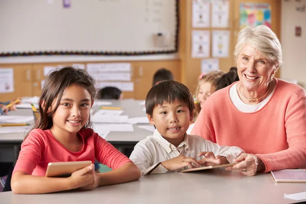 Senior teacher and pupils in classroom