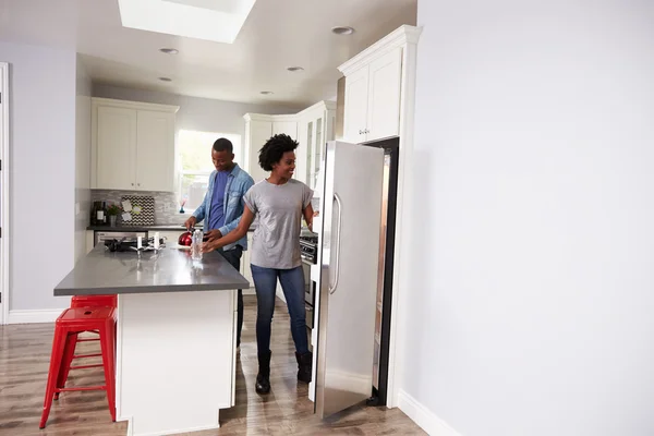 Young Couple Relaxing In Kitchen