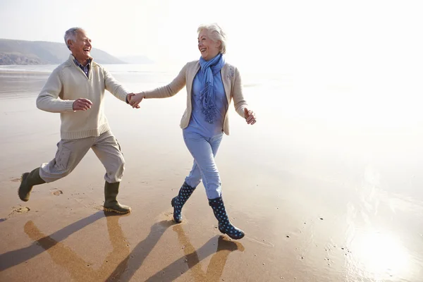 Senior Couple Running on Winter Beach