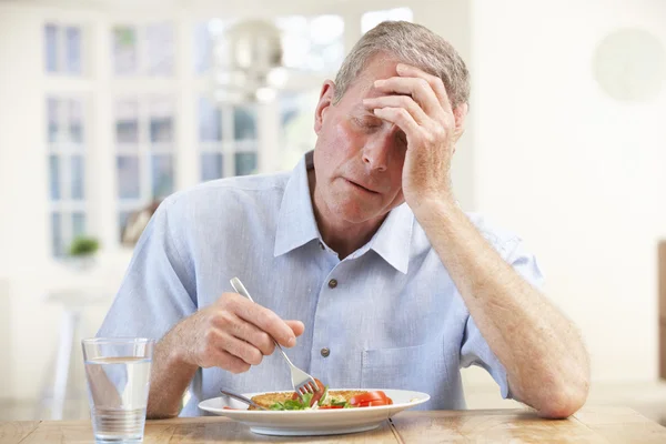 Sick man trying to eat